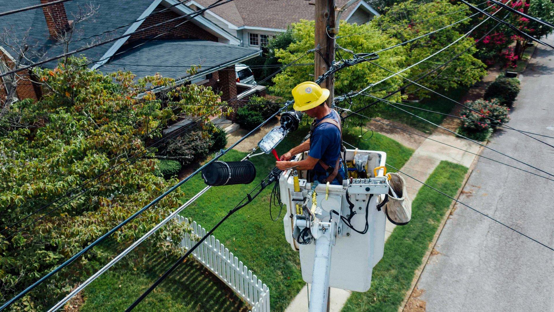 Utility worker servicing power lines